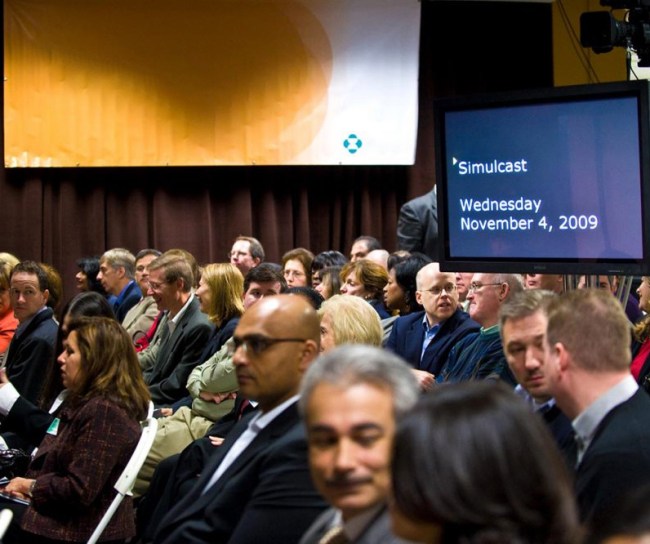Many people sitting in a lecture hall