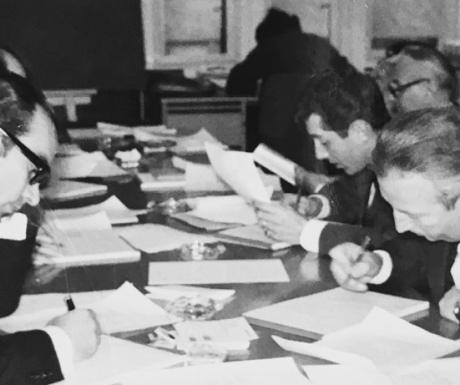 Men sit at the table and sign contracts