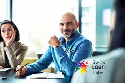 A men sitting on the table, smiling during a meeting