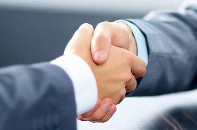 Two men shake hands
