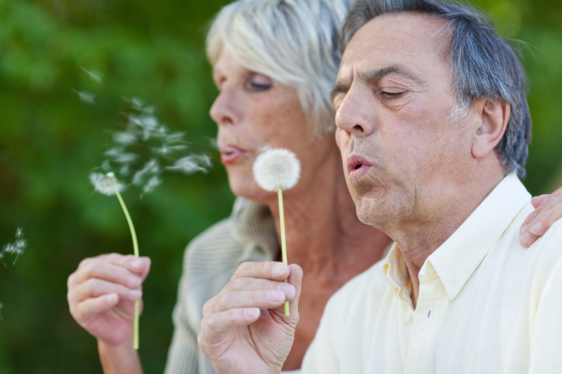 couple blowing blowballs