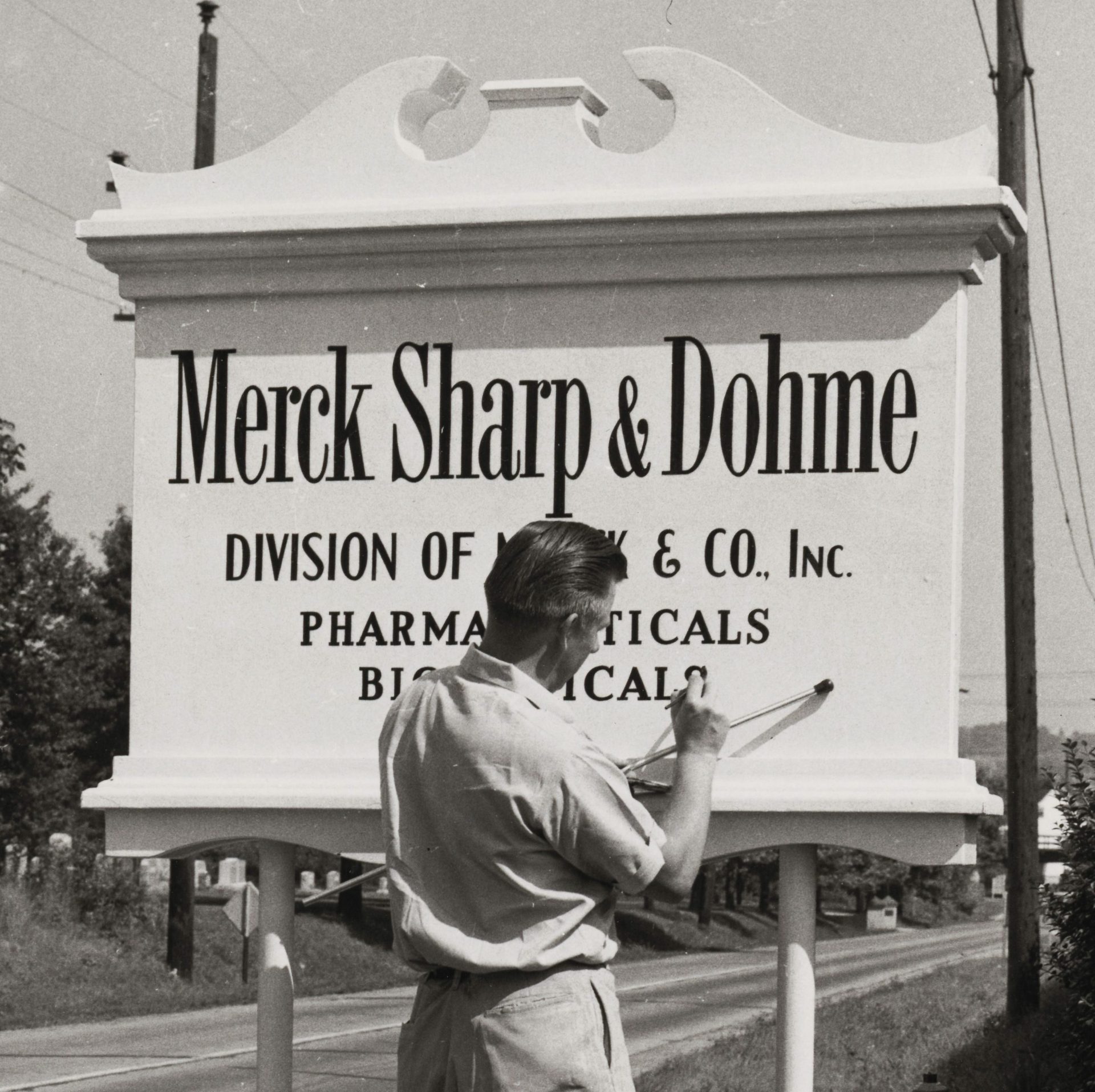 Man writing MSD Merck Sharp & Dohme sign