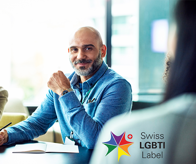 A man sitting at the table smiling during a meeting